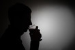 silhouette of a young man with a glass of red wine silhouette of a young man with a glass of red wine