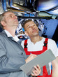 Master mechanics in garage checking engine bay for an offer