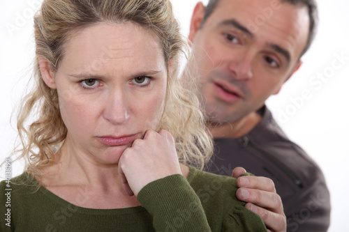 Photo: Man trying to comfort his grumpy wife Man trying to comfort his grumpy wife