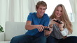 Smiling couple playing video games together