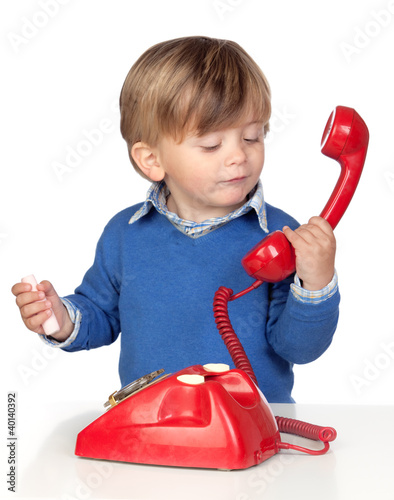 Photo: Beautiful baby with a red phone Beautiful baby with a red phone
