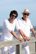 Father and son stood at the pier