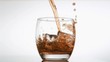 Whiskey poured in super slow motion in a glass with ice