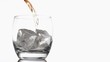 Whiskey poured in super slow motion in a glass with ice