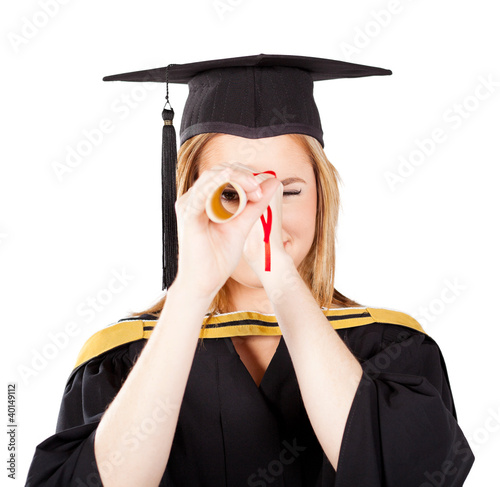 Photo: funny female graduate looking through her certificate funny female graduate looking through her certificate