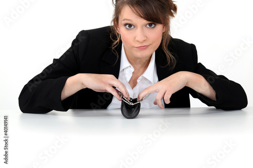 Photo: Office worker sat with empty purse Office worker sat with empty purse