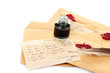 feather, ink and old letters isolated on white.