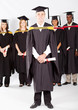 male college student at graduation with classmates