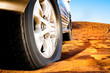 wheel of a car on the sand
