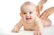 baby lying isolated getting massage from mother's hands