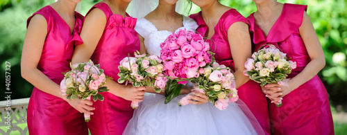 Photo: Row of bridesmaids with flowers Row of bridesmaids with flowers