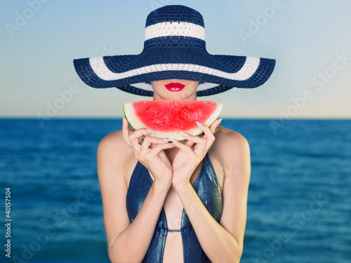 Photo: Young lady at sea with watermelon Young lady at sea with watermelon