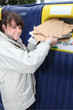 Woman using recycling bin for paper