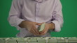 Man Puts Dolars in a Heap