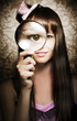 Beautiful female watching through magnifying glass
