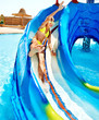 Child on water slide at aquapark.