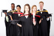 group of multiracial graduates at graduation holding caps