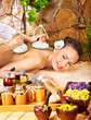 Woman getting thai herbal compress massage . Woman getting thai herbal compress massage .