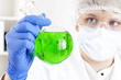 female chemist mixing liquids in test tubes female chemist mixing liquids in test tubes