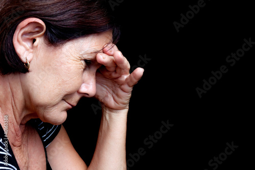 Photo: Older woman with a strong headache Older woman with a strong headache