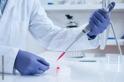 Photo: Scientist processing DNA sample in laboratory Scientist processing DNA sample in laboratory