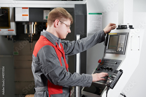Photo: laborer working with machine tool laborer working with machine tool
