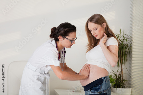 Photo: Pregnant woman and doctor.. Pregnant woman and doctor..