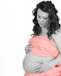 Photo: closeup of beautiful pregnant woman in peach drape. selective co closeup of beautiful pregnant woman in peach drape. selective co