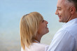Mature couple smiling at the seaside