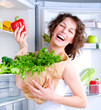 Beautiful Young Woman near the Refrigerator with healthy food