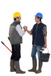 Two construction workers greeting each other