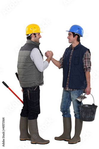 Photo: Two construction workers greeting each other Two construction workers greeting each other