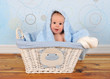 cute baby boy sitting in basket with blanket on head