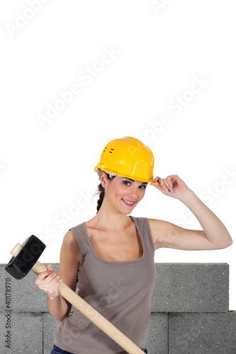 Photo: Woman with helmet and mallet in hand Woman with helmet and mallet in hand