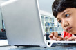 Serious boy Learning computer technology from laptop