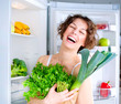 Beautiful Young Woman near the Refrigerator with healthy food