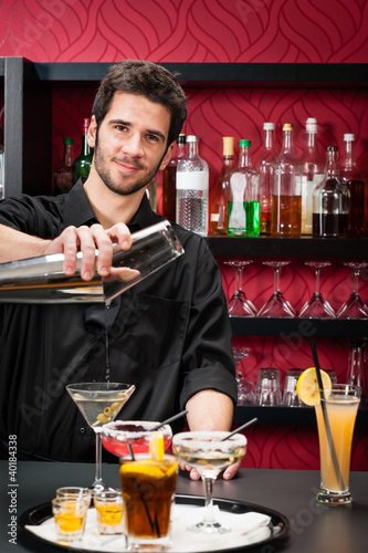 Photo: Young bartender make cocktail shaking drinks Young bartender make cocktail shaking drinks