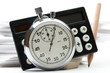 Pile of paper cards, calculator and stopwatch