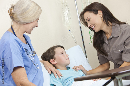 Photo: Boy Child Patient In Hospital Bed With Mother & Doctor Boy Child Patient In Hospital Bed With Mother & Doctor
