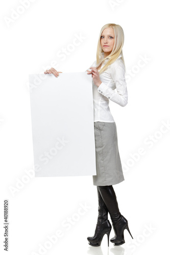 Photo: Full length of young female holding the blank board Full length of young female holding the blank board