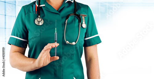 Photo: medical nurse holding injection needle medical nurse holding injection needle