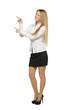 Full length of beautiful business woman pointing at copy space