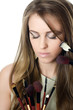 The beautiful girl with brushes for a make-up