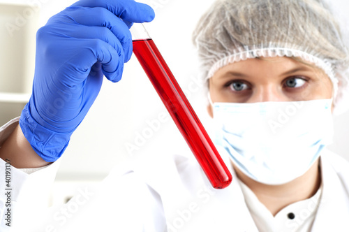 Photo: female chemist mixing liquids in test tubes female chemist mixing liquids in test tubes