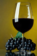 A glass of red wine and grapes A glass of red wine and grapes