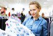 Woman in a shop buying clothes