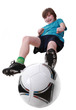 Foto: Boy beating on a ball in a jump on a white background Boy beating on a ball in a jump on a white background