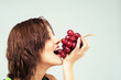Beautiful woman eating grapes Beautiful woman eating grapes