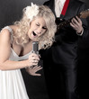 Fashion model in wedding dress with microphone in hand Fashion model in wedding dress with microphone in hand