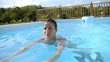 Young beautiful woman swimming in private pool